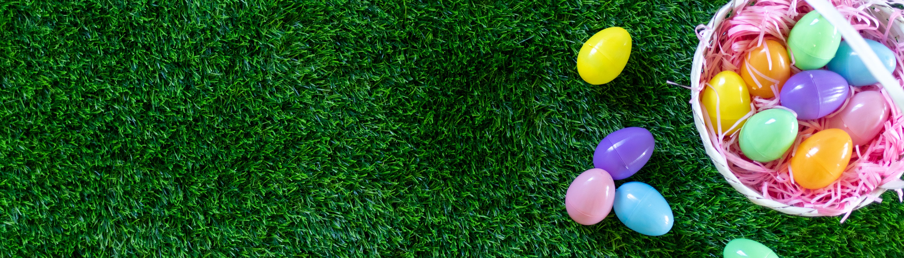 Plastic eggs scattered on a turf background