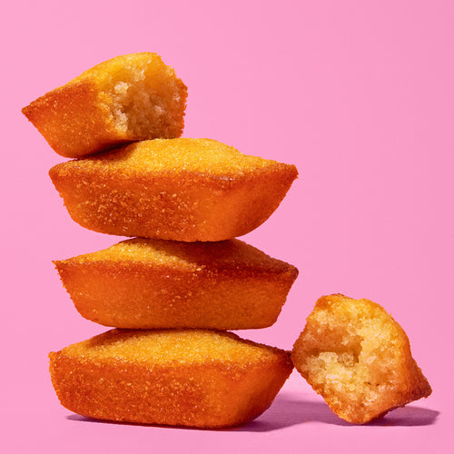 A stack of Almond Butter Cakes produced by Belgian Boys on a pink background